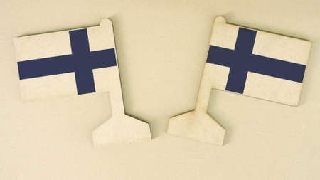 Two flags of Finland made of cardboard on the desk, flat layout