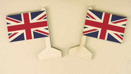 Two flags of the United Kingdom made of recycled paper on the cardboard desk, flat layoutの写真素材