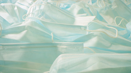 Used medical disposable face masks, close-up shot.の写真素材