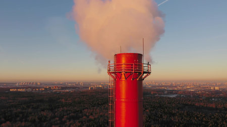 Aerial shot of an air polluting industrial red smoke stackの写真素材