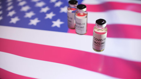 Vials with COVID-19 vaccine and flag of the United Statesの写真素材