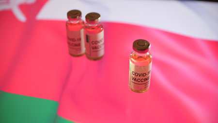 Vials with COVID-19 vaccine and national flag of Omanの写真素材