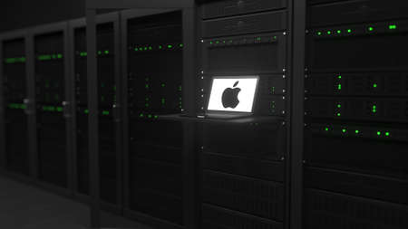 Laptop with the logo of APPLE INC. on the screen in a server room. Conceptual editorial 3d rendering