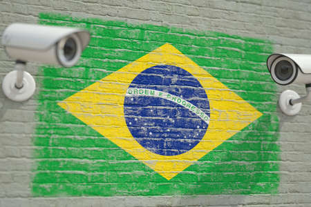 Wall with national flag of Brazil and CCTV cameras. Privacy or surveillance system related conceptual 3D renderingの写真素材