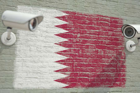 Surveillance cameras and wall with flag of Qatar. Modern security related 3D renderingの写真素材