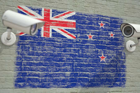 Surveillance cameras and wall with flag of New Zealand. Modern security related 3D renderingの写真素材