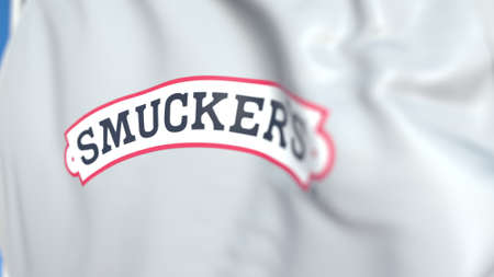 Flying flag with The J. M. Smucker Company logo, close-up. Editorial 3D rendering