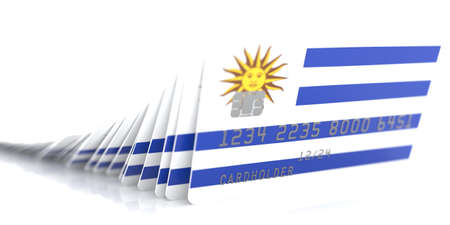 Line of fallen credit cards with flags of Uruguay on white background, 3d renderingの写真素材