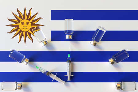 Syringes and medical vials on the flag of Uruguay. Vaccination related conceptual 3D renderingの写真素材