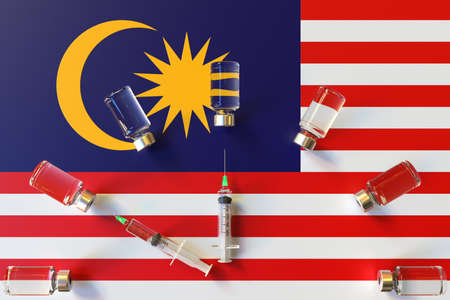 Glass vials and syringes on the flag of Malaysia. Vaccination related conceptual 3D renderingの写真素材