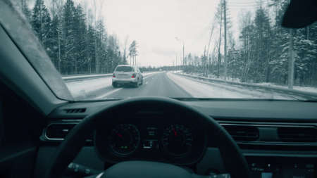MOSCOW REGION, RUSSIA - DECEMBER 26, 2021. Driving a car along rural higway in winter, POV shotのeditorial素材