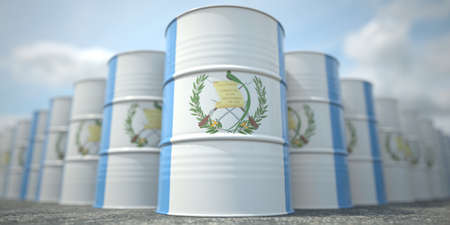 Many barrels with flag of Guatemala. Oil or chemical industry supply related 3D renderingの写真素材