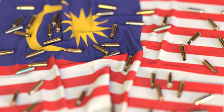 Scattered bullet shells on the flag of Malaysia. Crime or violence related 3D renderingの写真素材