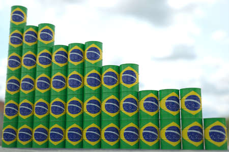 Rows of steel oil barrels with flag of Brazil form downward trend. Petroleum industry crisis concept, 3D renderingの写真素材