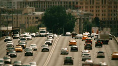 Wide and busy city street traffic on a hot sunny day, tele lens shotの写真素材