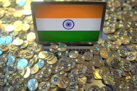 Laptop with flag of India and pile of bitcoins. Cryptocurrency mining and national regulations...