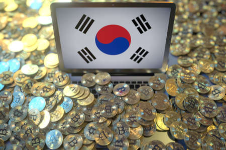 Flag of South Korea on the laptop screen and many bitcoins. National cryptocurrency regulations and...