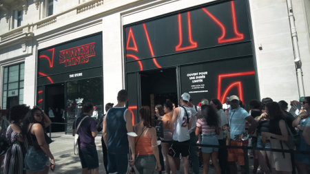 PARIS, FRANCE - JULY 14, 2022. Crowded entrance of the Stranger Things Store on Champs-Elysees...