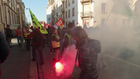 MULHOUSE, FRANCE - FEBRUARY, 2023 Yellow vest protester holding smoke flare in the streetのeditorial素材