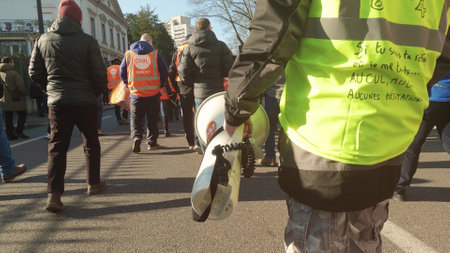 MULHOUSE, FRANCE - FEBRUARY, 2023 Street yellow vest protester holding megaphoneのeditorial素材