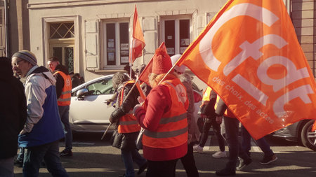 MULHOUSE, FRANCE - FEBRUARY 7, 2023 CFDT or French Democratic Confederation of Labour protesters walk down the street in Mulhouseのeditorial素材