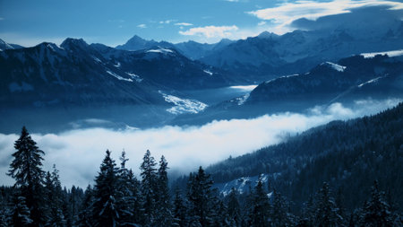 Snow covered Swiss Alps mountains and curling fog in the valleyの写真素材