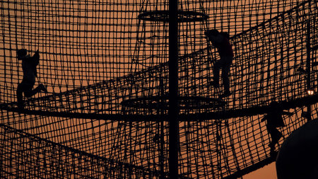 Kids and playground silhouettes on evening sky backgroundの写真素材