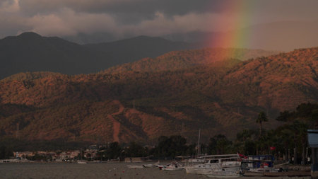 Rainbow over green coastal hills near Fethiye, Turkeyの写真素材