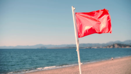 Red flag on the beach as a hazard of high surf or strong sea currentsの写真素材