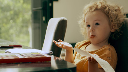 Disappointed little girl holding a piece of paper