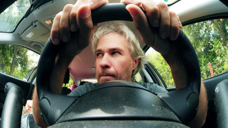 Fisheye lens portrait of a suspicious male driver in the carの写真素材