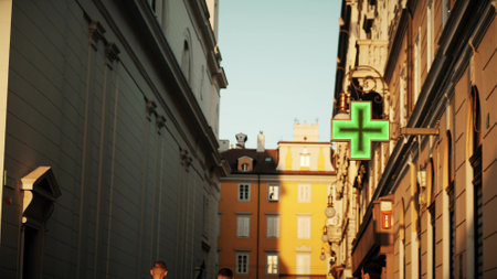 Green cross LED sign at the entrance to pharmacy in Trieste, Italyの写真素材