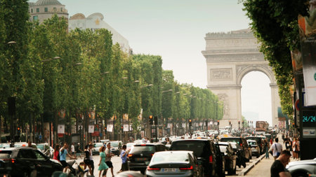 PARIS, FRANCE - JUNE 12, 2023. Road traffic on Avenue des Champs-Elysees and distant Arc de Triomphe or Triumphal Archのeditorial素材