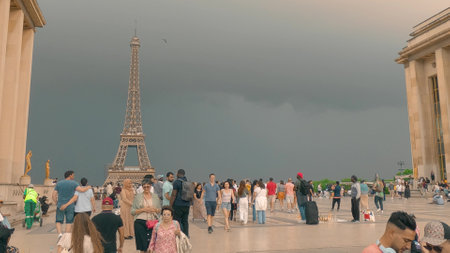 PARIS, FRANCE - JUNE 11, 2023. People on Trocadero Square at the Eiffel Tower on stormy clouds backgroundのeditorial素材