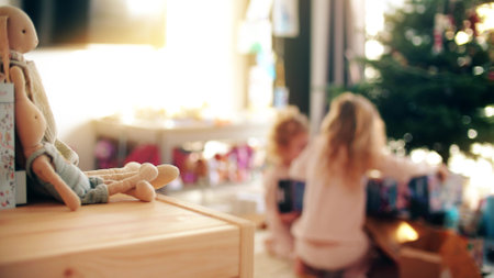Defocused kids enjoy unboxing Christmas or New Year gifts at home in the morningの写真素材