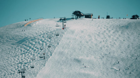 Alpine ski track and lift on the mountain slope in famous Alpe dHuez ski resort, Franceの写真素材