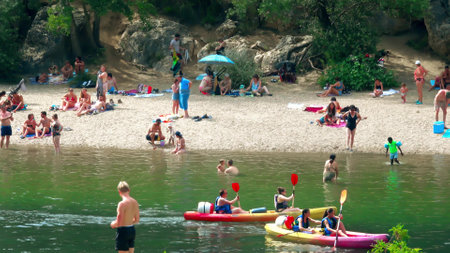VERS-PONT-DU-GARD, FRANCE - AUGUST 2, 2023. Crowded beach of the River Gardon close to famous Pont du Gard aqueductのeditorial素材