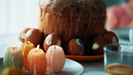 Easter bread, eggs and candles on a holiday table at home