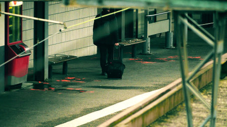 An unknown male passenger with the suitcase on the railway platformの写真素材