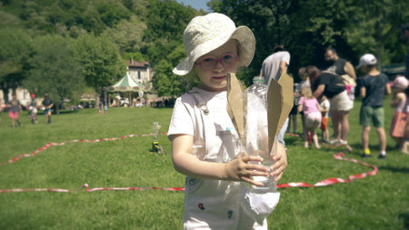 A smart little girl holds her bottle water rocket at the launch padの写真素材