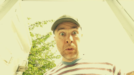 A man looking surprised while opening his mailbox