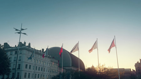 Waving flags of Lyon, France, and the European Union with the Lyon Opera House and Metallic tower of Fourviere rising on the hill. Cultural landmark and city identity of Lyonの写真素材