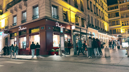 LYON, FRANCE - NOVEMBER 8, 2025. Evening street scene near famous Pralus bakery and patisserieのeditorial素材