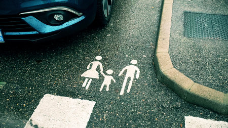 Family parking symbol on wet asphaltの写真素材
