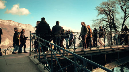 ANNECY, FRANCE - DECEMBER 27, 2025. Embankment and pedestrian bridge in city centre