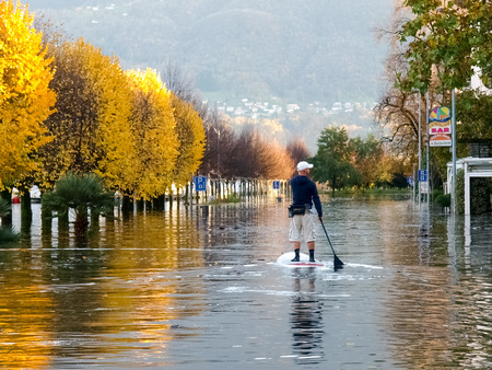 Locarno Ticino, Switzerland - November 13, 2014: unknown people surfing on the flooded roadのeditorial素材