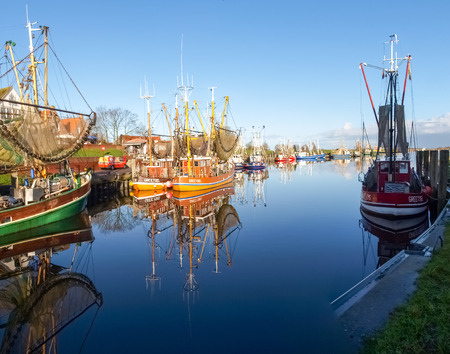 Greetsiel, Germany - December 6, 2014: Tourist city to the North Sea with a small port. There are several boats moored typical for fishing.のeditorial素材