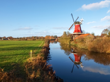 Greetsiel, Germany - December 6, 2014: Traditional Windmill working and still used to grind. The second mill is currently under renovation due to a violent hurricane.のeditorial素材