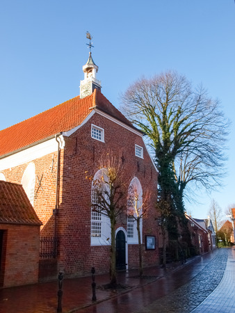 Greetsiel, Germany - December 6, 2014: Tourist town maintained as in antiquity. The typical houses are built of red brick. In the village there is a small harbor.のeditorial素材