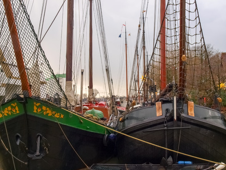 Leer, Germany - December 8, 2014: Ancient boats moored in the marina. The exposure to the public is free to visiting tourists.のeditorial素材